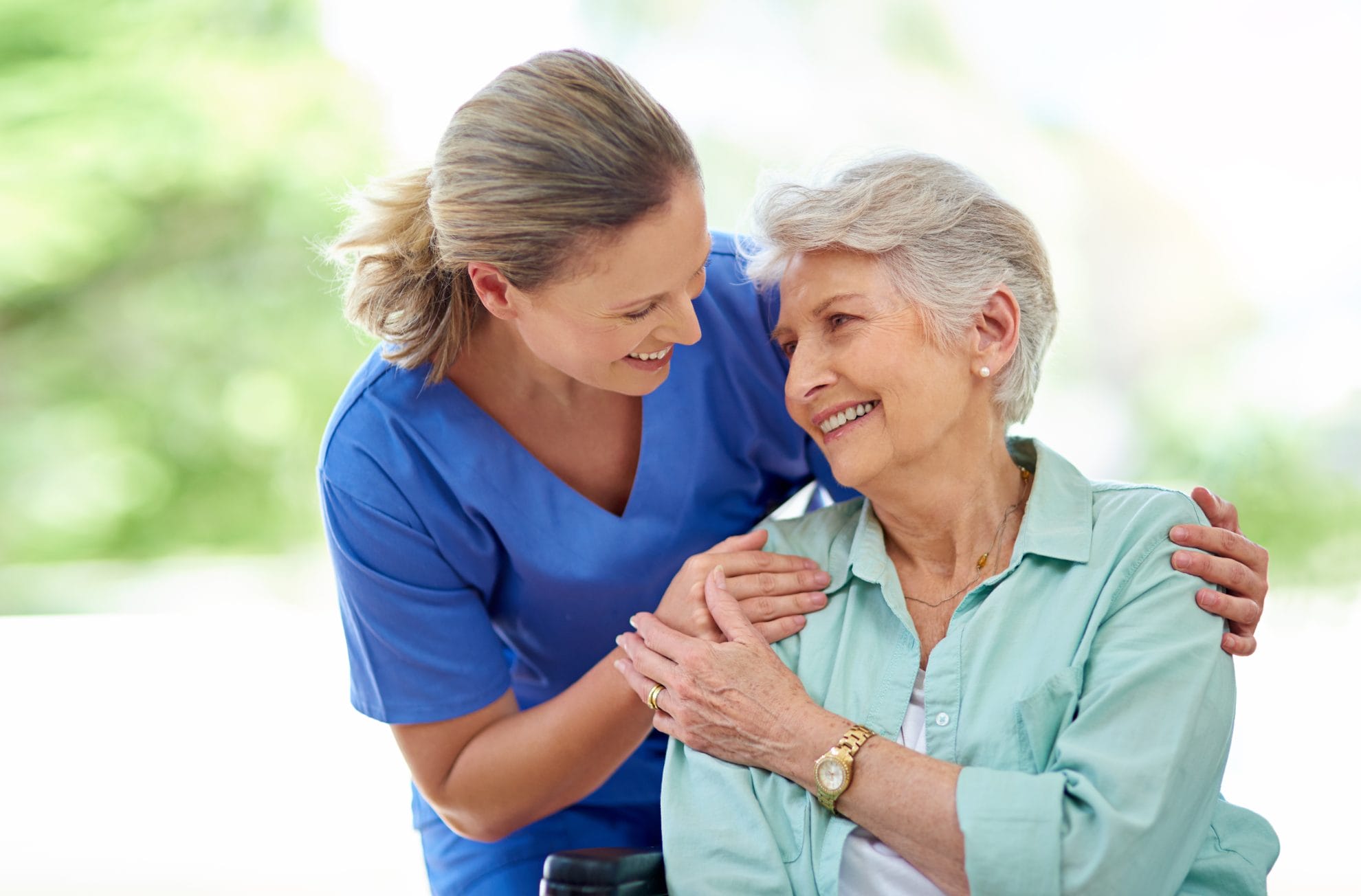 Caregiver and senior woman sharing a smile.