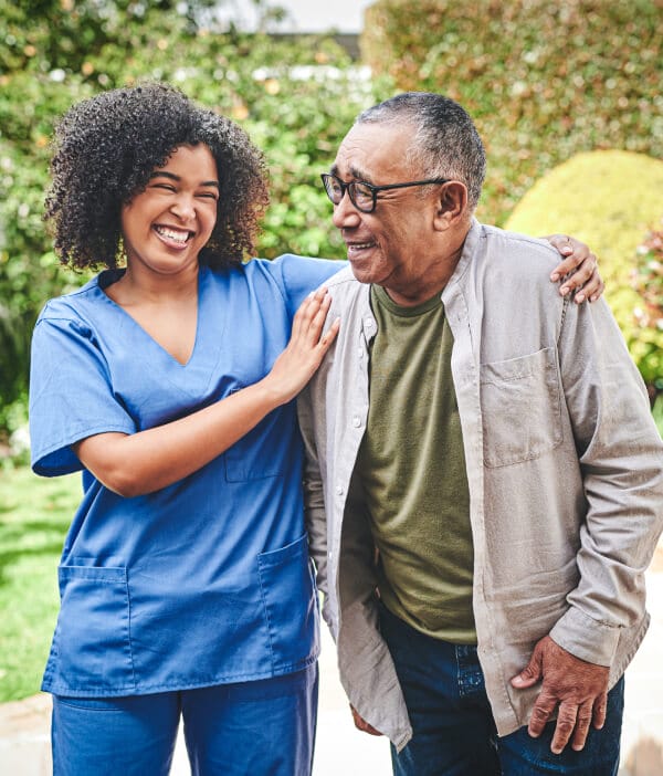 Care giver and senior man walking