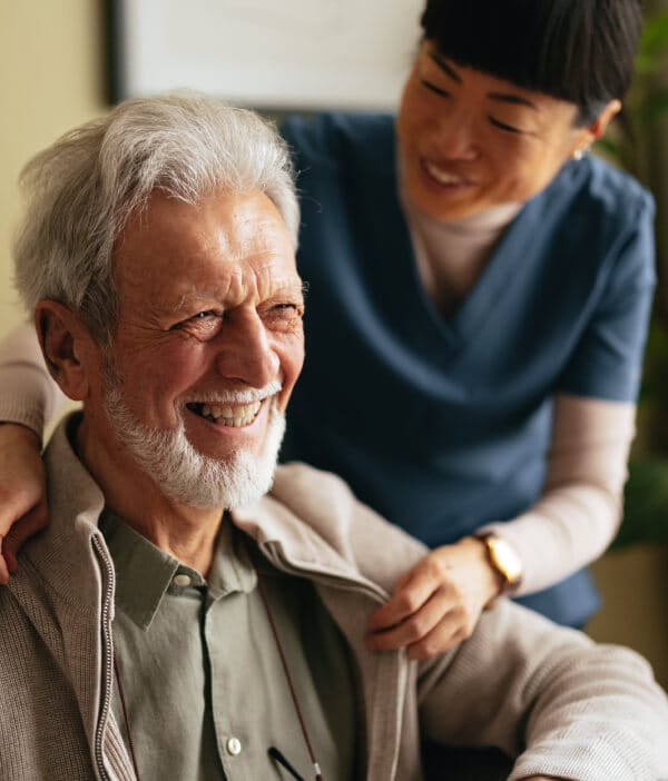 Care worker supporting senior man