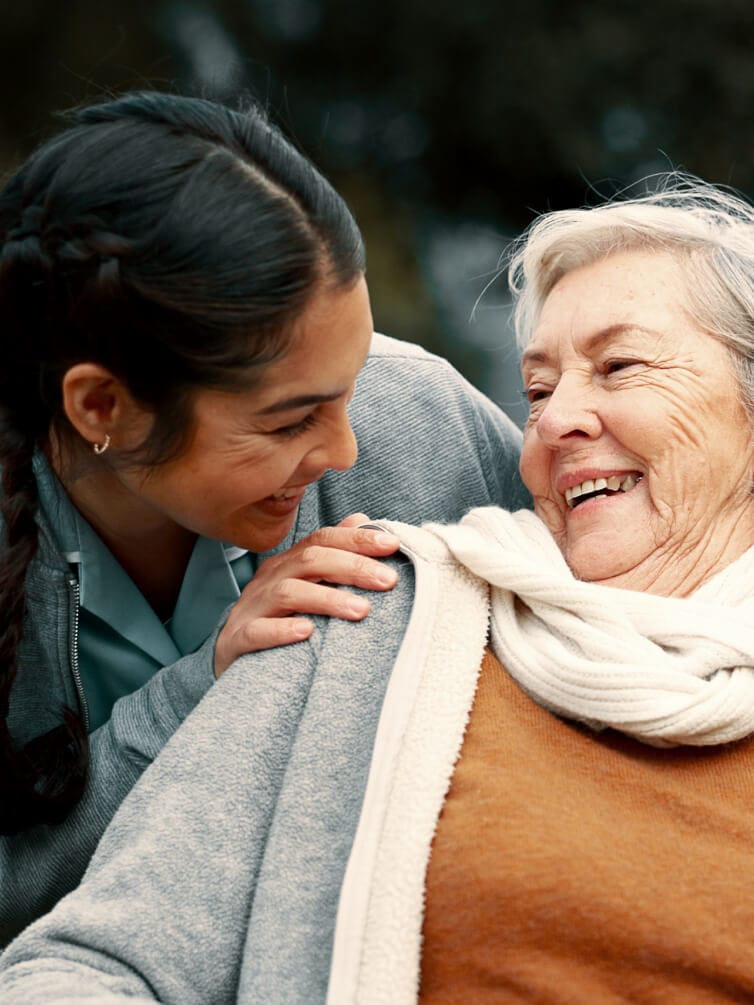 Caregiver supporting disabled person outdoors