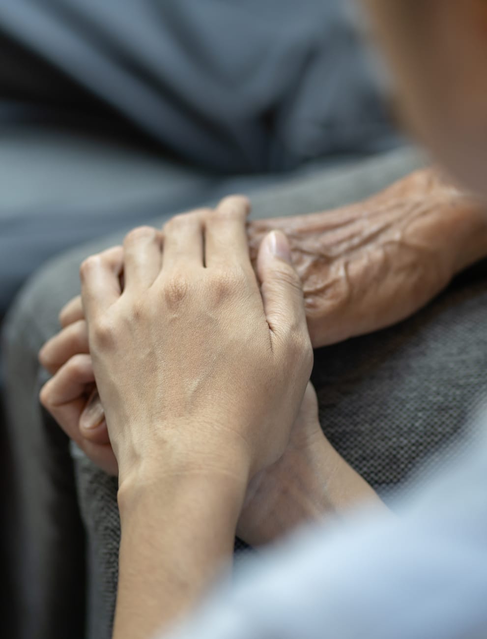Holding hands caregiving moment.