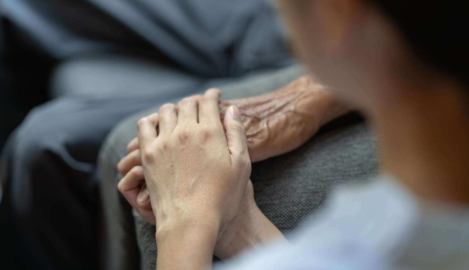 Holding hands caregiving moment