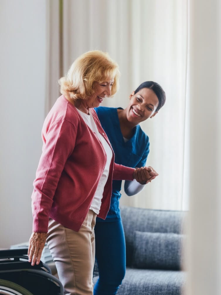Nurse assisting senior with mobility