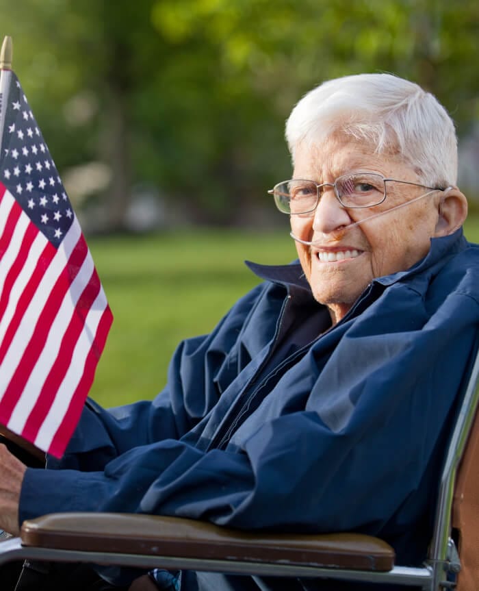 Senior veteran holding US flag