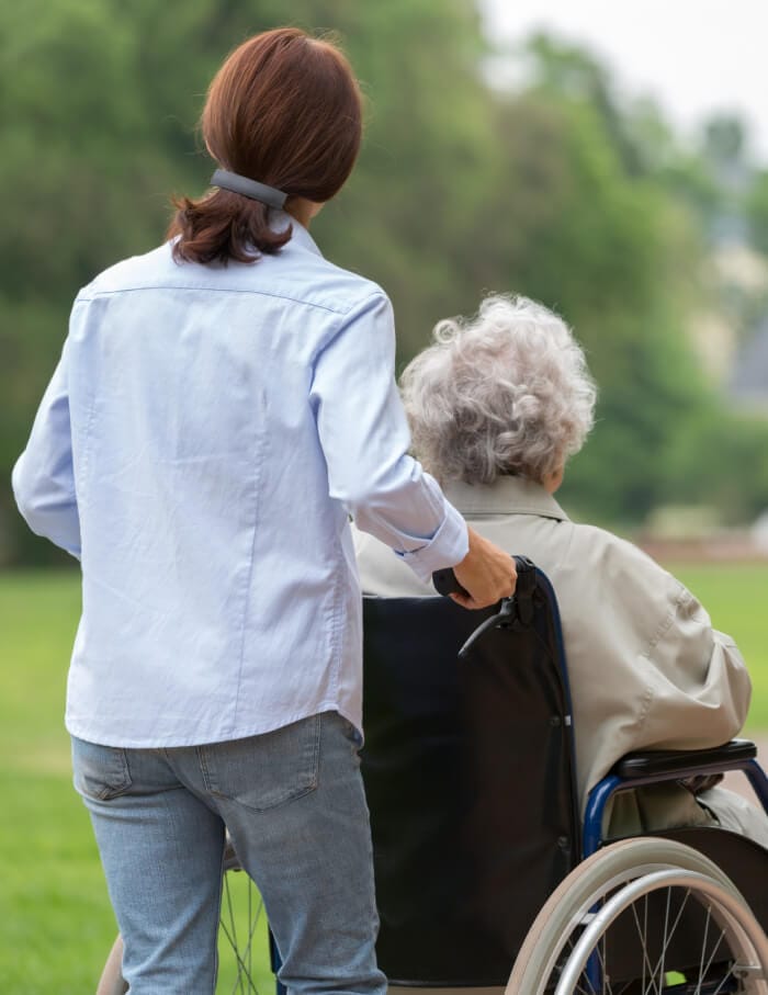 Senior woman with caregiver in the park