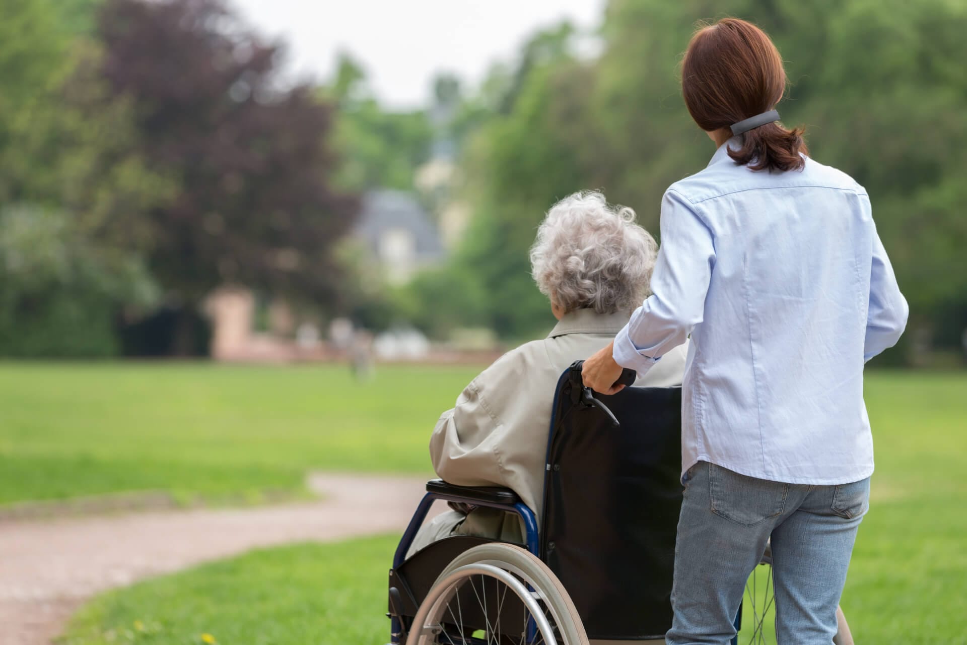 Senior woman with caregiver in the park