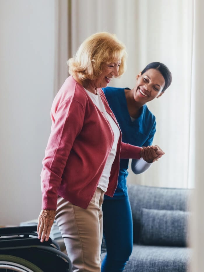 Nurse assisting senior with mobility