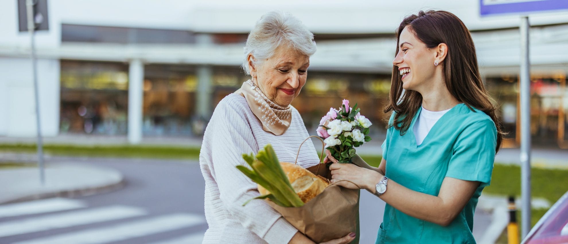 Caregiver assisting senior woman with grocery shopping